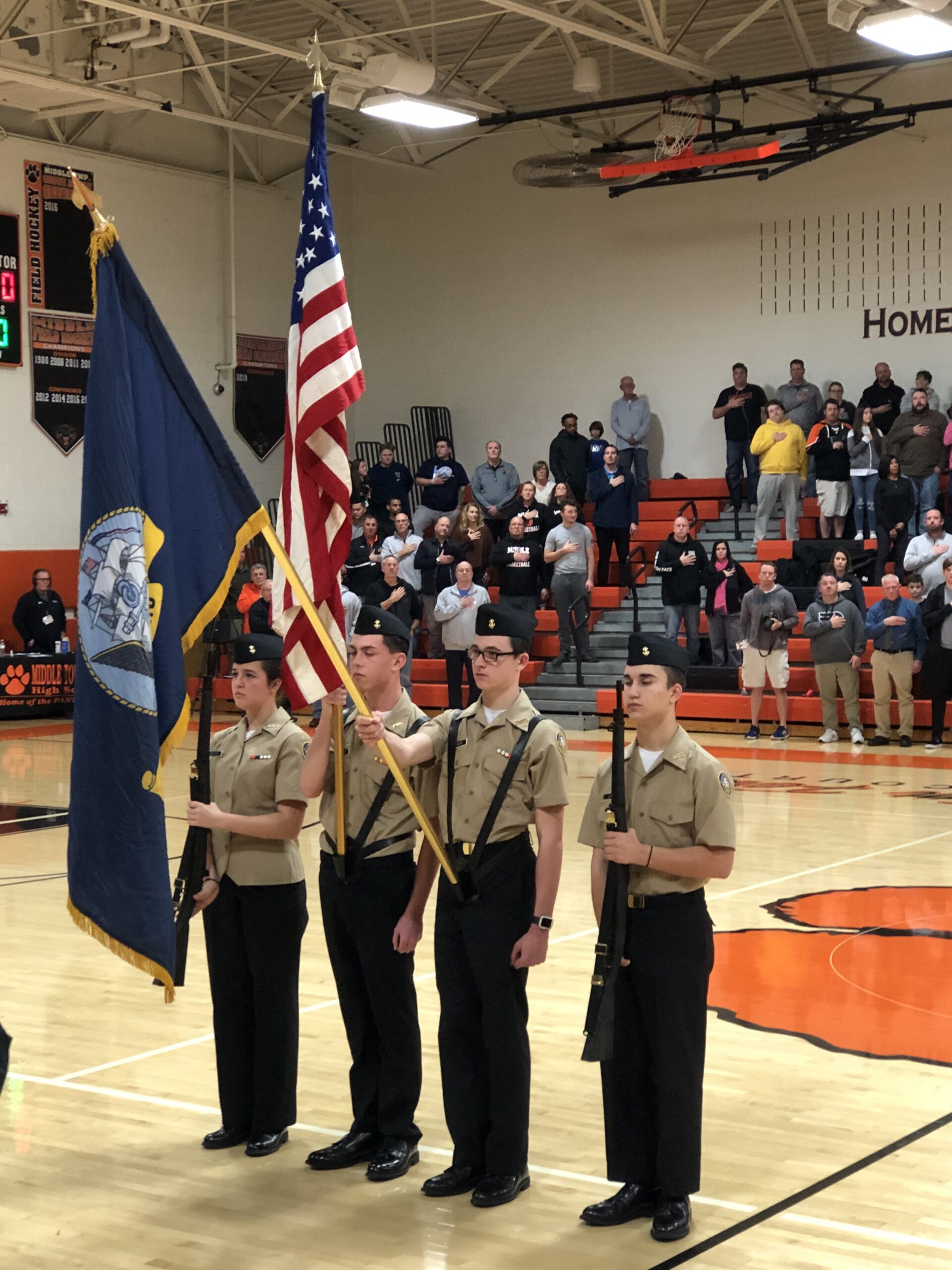 MTHS NNDCC Color Guard Team displaying the American Flag and the State Flag during a sporting event